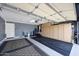 Well-organized garage with ample storage cabinets, black mats, and a modern garage door system at 10786 W Chisholm Dr, Sun City, AZ 85373