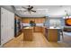 Well-equipped kitchen with stainless appliances, granite countertops, a center island, and generous cabinet space at 10786 W Chisholm Dr, Sun City, AZ 85373
