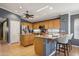 Open kitchen featuring wood cabinets, granite countertops, and stainless steel appliances at 10786 W Chisholm Dr, Sun City, AZ 85373