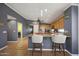 Eat-in kitchen features modern stainless steel appliances, granite countertops, a breakfast bar, and modern pendant lights at 10786 W Chisholm Dr, Sun City, AZ 85373