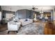 Open-concept living room with tile floors and a ceiling fan connecting to the kitchen at 10786 W Chisholm Dr, Sun City, AZ 85373