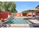 Sparkling pool featuring a stone water feature and umbrella shaded lounge area at 10786 W Chisholm Dr, Sun City, AZ 85373