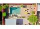 Aerial view of a private pool with lounge chairs, patio area, and well-kept landscaping within a walled backyard at 10786 W Chisholm Dr, Sun City, AZ 85373