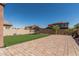 Backyard showcasing artificial turf, brick pavers and space for outdoor activities at 10827 W Bronco Trl, Peoria, AZ 85383