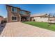 Large backyard featuring pavers, artificial turf, and a covered patio with a swing at 10827 W Bronco Trl, Peoria, AZ 85383