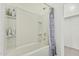 Well-lit bathroom featuring a tub-shower combo with handy shelving at 10827 W Bronco Trl, Peoria, AZ 85383