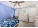 Bedroom featuring ceiling fan, desk, window with shutters, and a dresser at 10827 W Bronco Trl, Peoria, AZ 85383