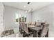 Formal dining room with seating for eight and large window at 10827 W Bronco Trl, Peoria, AZ 85383
