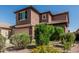 Two-story home featuring a tile roof, attached garage and desert landscaping at 10827 W Bronco Trl, Peoria, AZ 85383