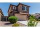 Two-story home featuring a tile roof, attached garage and desert landscaping at 10827 W Bronco Trl, Peoria, AZ 85383