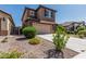 Two-story home featuring a tile roof, attached garage and desert landscaping at 10827 W Bronco Trl, Peoria, AZ 85383