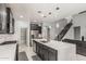 Gourmet kitchen featuring stainless appliances, large island, and stairway access at 10827 W Bronco Trl, Peoria, AZ 85383
