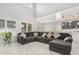 Open concept living room featuring high ceilings and large sectional sofa at 10827 W Bronco Trl, Peoria, AZ 85383