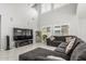 Bright living room featuring high ceilings and large sectional sofa at 10827 W Bronco Trl, Peoria, AZ 85383