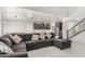 Open concept living room featuring high ceilings and large sectional sofa at 10827 W Bronco Trl, Peoria, AZ 85383