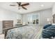 Bright bedroom with stylish shutters, ceiling fan, and a dresser set at 10827 W Bronco Trl, Peoria, AZ 85383