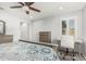 Bright bedroom including a ceiling fan, desk with chair, and dresser at 10827 W Bronco Trl, Peoria, AZ 85383