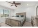 Comfortable main bedroom with ceiling fan, plush carpeting, and a view through shuttered windows at 10827 W Bronco Trl, Peoria, AZ 85383