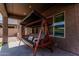 Relaxing porch with a comfortable swing seat and shaded area at 10827 W Bronco Trl, Peoria, AZ 85383