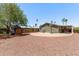 Spacious backyard features a basketball court, covered patio, shed and desert landscaping at 10951 N 91St Ave # 84, Peoria, AZ 85345