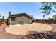 The backyard features a sport court, desert landscape and wooden fence at 10951 N 91St Ave # 84, Peoria, AZ 85345
