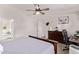 Bedroom with ceiling fan, office area, and view to primary bath at 10951 N 91St Ave # 84, Peoria, AZ 85345