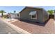 View of the exterior with awning-shaded windows and low-maintenance rock landscaping at 10951 N 91St Ave # 84, Peoria, AZ 85345