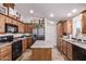Bright kitchen with wooden cabinets, stainless steel appliances, and decorative accents at 10951 N 91St Ave # 84, Peoria, AZ 85345