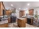 Well-lit kitchen boasts wood cabinets, center island and stainless steel refrigerator at 10951 N 91St Ave # 84, Peoria, AZ 85345