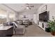 Comfortable living room with neutral tones, plush seating, and a ceiling fan at 10951 N 91St Ave # 84, Peoria, AZ 85345