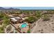 Stunning aerial view of a southwest-style house with a private pool, desert landscaping, and mountain views at 11238 N 11Th St, Phoenix, AZ 85020