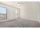 Bright bedroom featuring neutral carpet, ceiling fan, and windows with mountain views at 11238 N 11Th St, Phoenix, AZ 85020