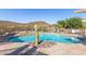 Beautiful community pool with a spa, desert landscaping, mountain views, and caution signs for safety at 11238 N 11Th St, Phoenix, AZ 85020
