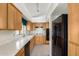 Functional kitchen featuring wood cabinets, quartz countertops, and modern appliances at 11238 N 11Th St, Phoenix, AZ 85020