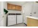 Functional laundry room with white cabinets and side-by-side washer and dryer at 11238 N 11Th St, Phoenix, AZ 85020