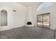 Bright living room featuring a fireplace and large windows showcasing outdoor pool at 11238 N 11Th St, Phoenix, AZ 85020
