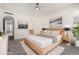 Serene bedroom with neutral tones, decorative art, a ceiling fan and an attached ensuite bathroom at 11238 N 11Th St, Phoenix, AZ 85020