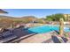 Inviting community pool and spa area with desert landscaping, lounge chairs and mountain views at 11238 N 11Th St, Phoenix, AZ 85020