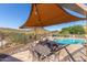 Relaxing poolside patio area with an outdoor dining set and lounge chairs under a shaded canopy at 11238 N 11Th St, Phoenix, AZ 85020
