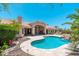 Expansive backyard showcasing the beautiful pool area and its connection to the home at 12120 E Cortez Dr, Scottsdale, AZ 85259