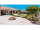 Lush backyard featuring a pool, built-in grill, fire pit, and putting green at 12120 E Cortez Dr, Scottsdale, AZ 85259