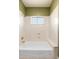 The white tub and shower features a single window and a built-in seat at 12120 E Cortez Dr, Scottsdale, AZ 85259