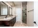 Bathroom with dual sinks and a walk-in shower with patterned tile at 12120 E Cortez Dr, Scottsdale, AZ 85259
