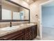 The bathroom has a double vanity with granite counters and dark wood cabinets at 12120 E Cortez Dr, Scottsdale, AZ 85259