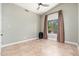 Neutral bedroom featuring tile floors, a ceiling fan, and a large window with curtains at 12120 E Cortez Dr, Scottsdale, AZ 85259