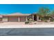 Beautiful single-story home featuring a tile roof, manicured landscaping, and a spacious three-car garage at 12120 E Cortez Dr, Scottsdale, AZ 85259