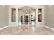 Welcoming foyer featuring tile floors, an elegant chandelier and large windows with backyard views at 12120 E Cortez Dr, Scottsdale, AZ 85259