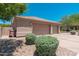 Exterior view of a three-car garage featuring neutral color and well maintained landscaping at 12120 E Cortez Dr, Scottsdale, AZ 85259