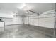 Spacious three car garage with white walls and sealed concrete floors at 12120 E Cortez Dr, Scottsdale, AZ 85259