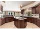 Gourmet kitchen with custom cabinets, granite countertops, and large center island at 12120 E Cortez Dr, Scottsdale, AZ 85259